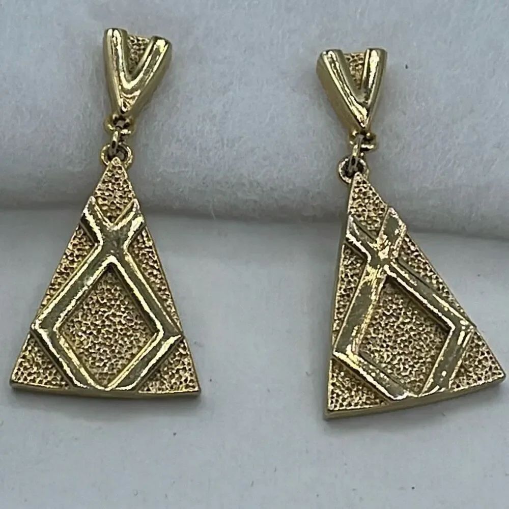 Vintage dangle clip style earrings gold colored triangle pattern.